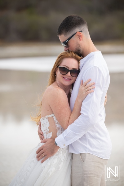 Couple enjoys trash the dress moment in Curacao at the beach during the day