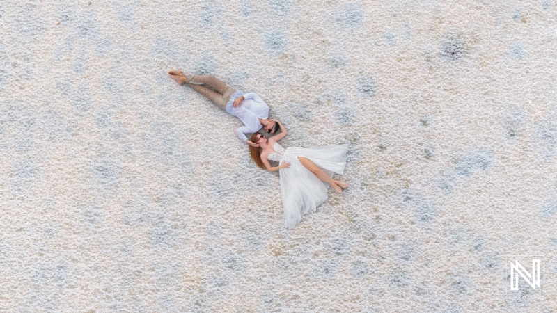 Couple embraces on a beach in Curacao during a trash the dress session