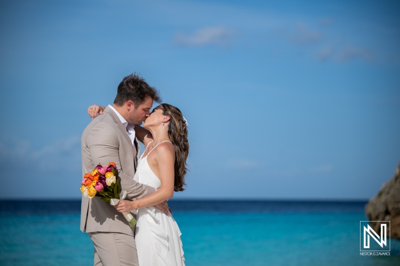 Couple enjoys Trash the Dress session at Cas Abao Beach in Curacao during bright sunny day with clear blue sky