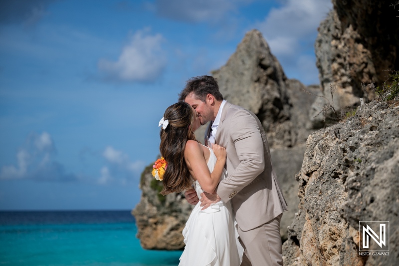 Couple shares a moment during trash the dress session at Cas Abao Beach in Curacao on a sunny day