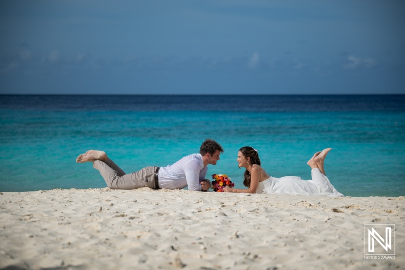Couple enjoy trash the dress session at Cas Abao Beach in Curacao on a sunny day by the ocean
