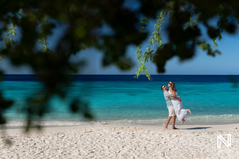 Couple celebrating love at Cas Abao beach in Curacao during a Trash The Dress session after their wedding