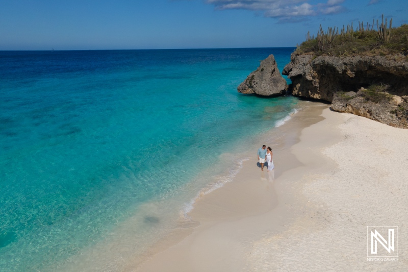 Couple enjoying a romantic trash the dress session on the stunning Cas Abao beach in Curacao under clear blue skies