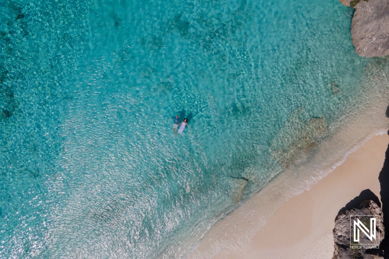 Couple enjoying a unique Trash The Dress experience in the clear waters of Cas Abao Beach in Curacao