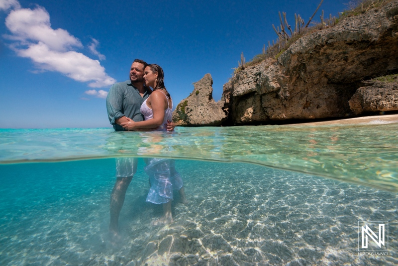 Couple enjoying a Trash The Dress session in Cas Abao Beach, Curacao under a bright sunlit sky