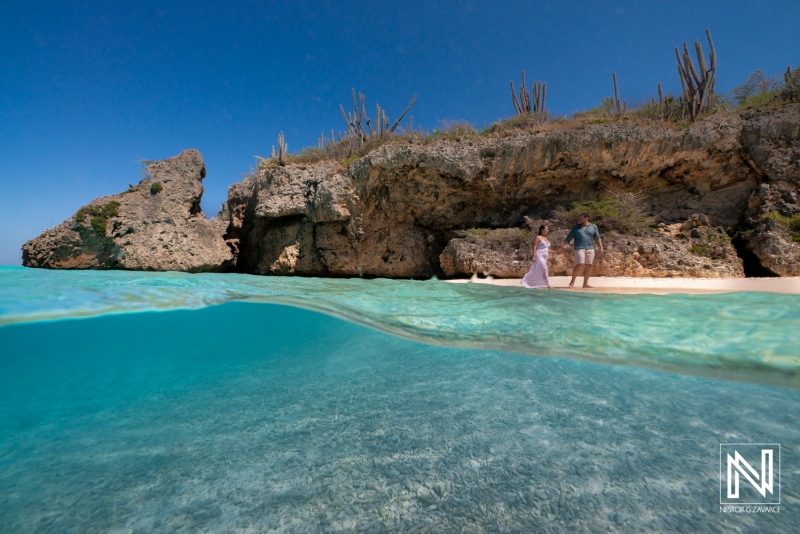 Couple enjoys a Trash The Dress session at Cas Abao beach in Curacao under a clear blue sky