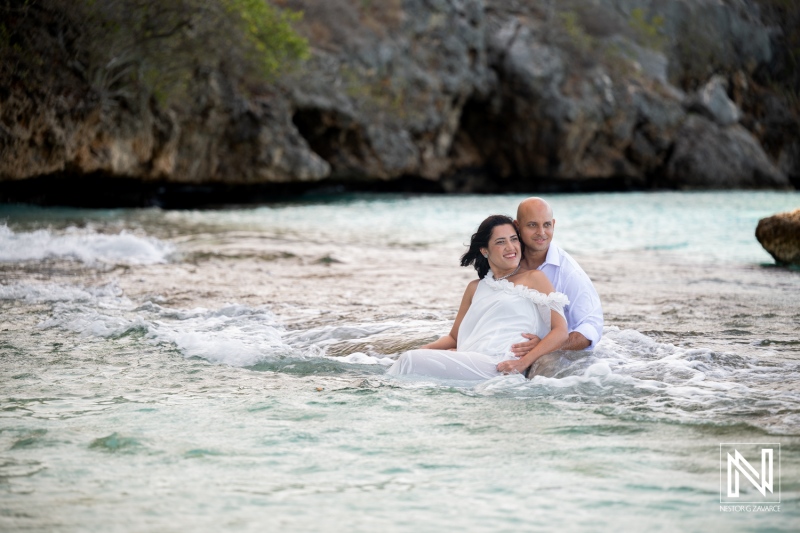 Couple enjoys a trash the dress session at Cas Abao Beach in Curacao while having fun in the water
