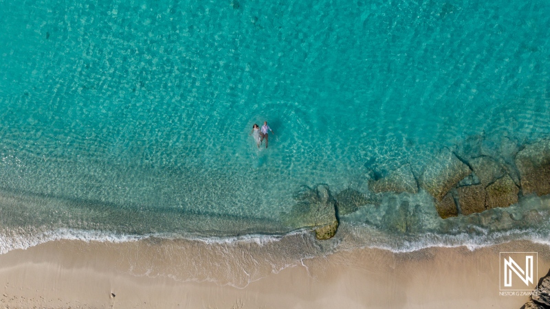 Trash the dress session at Cas Abao Beach in Curacao with couple playing in the water