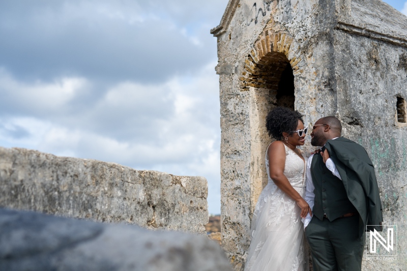 A Joyful Couple Exchanges Vows at a Historic Site in a Romantic Outdoor Ceremony Under a Beautiful Cloudy Sky During Sunset