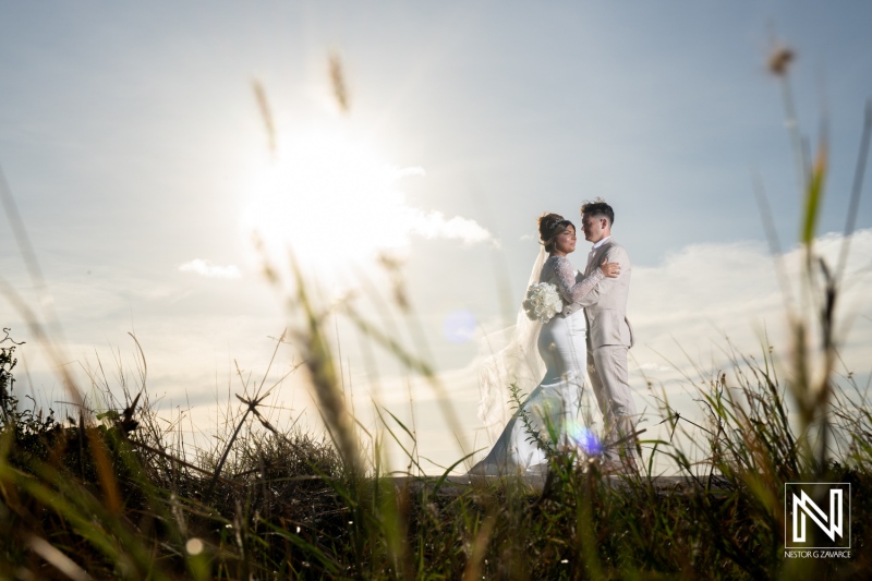 Couple embraces during Trash the Dress session at Boka Sami beach in Curacao under a bright sun