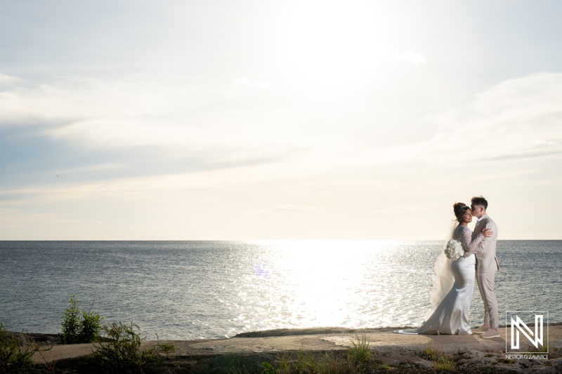 Couple shares romantic moment during Trash the Dress shoot at Boka Sami in Curacao under a bright sky