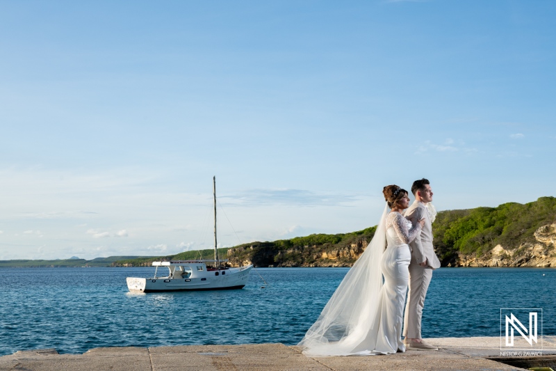 Beautiful couple enjoying a romantic moment during Trash the Dress session at Boka Sami in Curacao under a clear blue sky