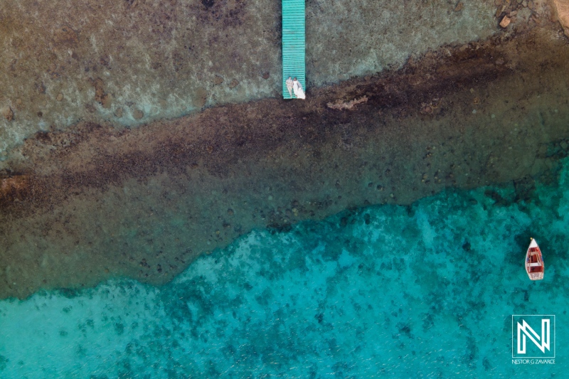 Couple enjoying a romantic trash the dress session at Boka Sami in Curacao with vibrant blue waters and serene surroundings
