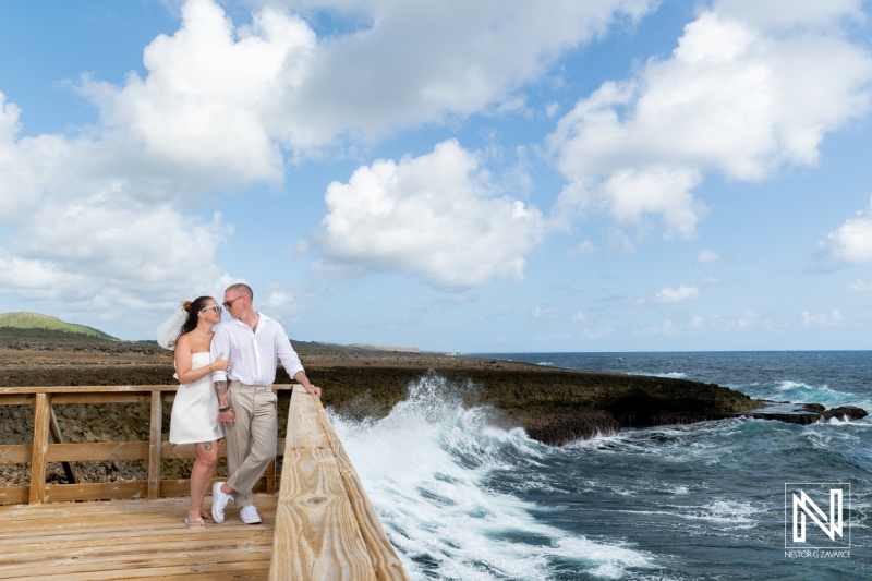 Couple enjoying a trash the dress session at Shete Boka National Park on a sunny day in Curacao