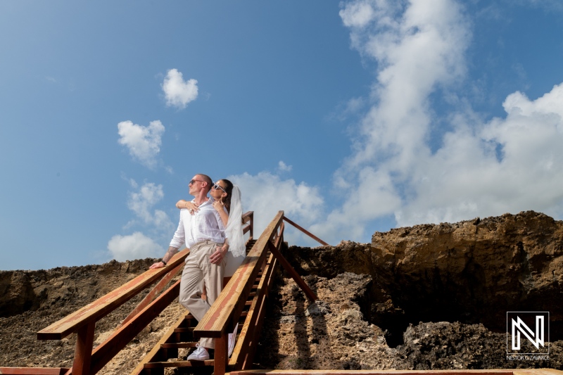 Beautiful couple enjoys their trash the dress session at Shete Boka National Park in Curacao under clear skies