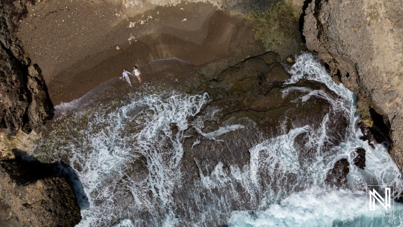 Stunning trash the dress session at Shete Boka National Park in Curacao with crashing waves and rocky coastline