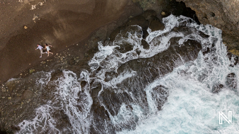 Beautiful couple enjoying a trash the dress session at Shete Boka National Park in Curacao with crashing waves