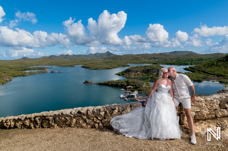 Couple celebrates love in elegant attire with stunning views at Santa Martha Bay, Curacao during a Trash the Dress session