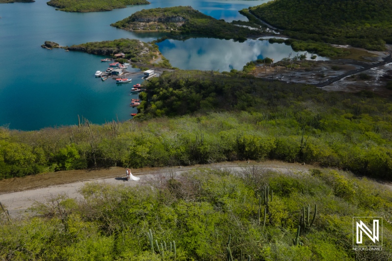 Couple enjoys a serene moment while trashing the dress at Santa Martha Bay in Curacao during a sunny afternoon