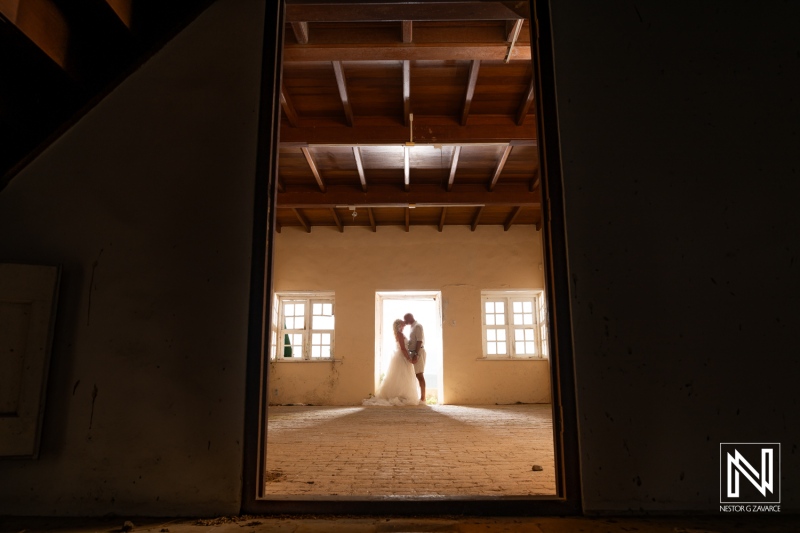 Couple embraces in a romantic moment at an elegant location in Curacao during a Trash the Dress session at Cas Abao Beach