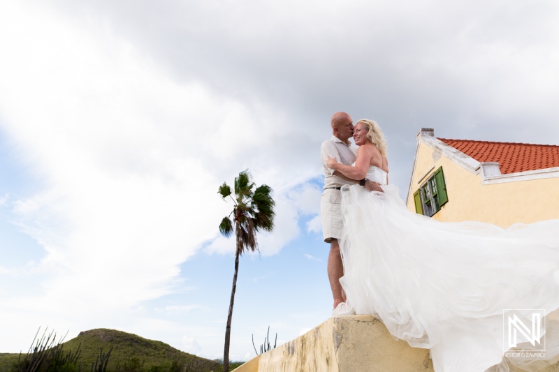 Couple embraces joyfully in wedding attire at Cas Abao Beach in Curacao during a Trash the Dress session