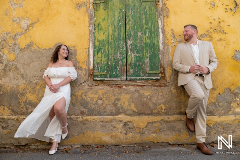 Bride and Groom beside a Yellow Wall in Punda