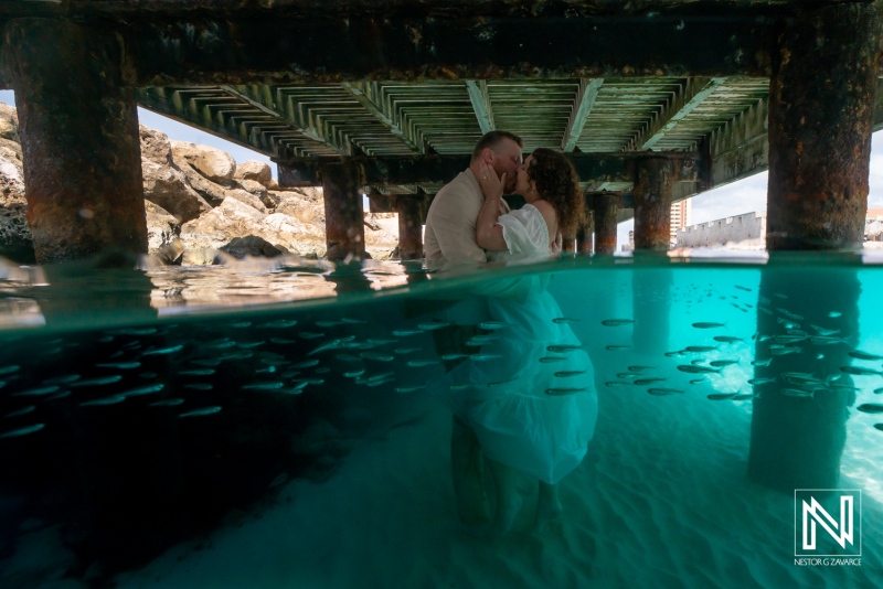 Couple Kissing in the Water beneath the Pier