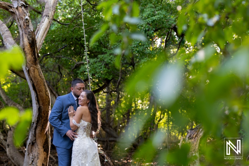 Couple celebrating love in a beautiful outdoor setting during a Trash the Dress session in Curacao, captured in natural light and lush greenery