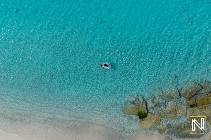 Trash the dress experience in breathtaking turquoise waters of Curacao with a couple enjoying their special day