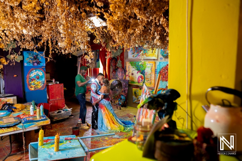 Capturing the vibrant transformation during a Trash the Dress session in Curacao blending colorful artistry with joyous post-wedding celebration