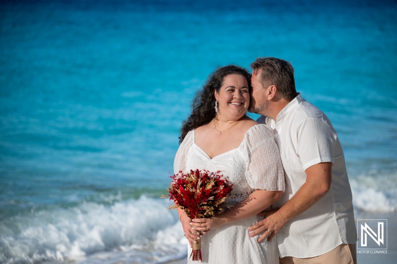 Couple enjoys trash the dress photoshoot at Cas Abao Beach in Curacao during a sunny day near the ocean