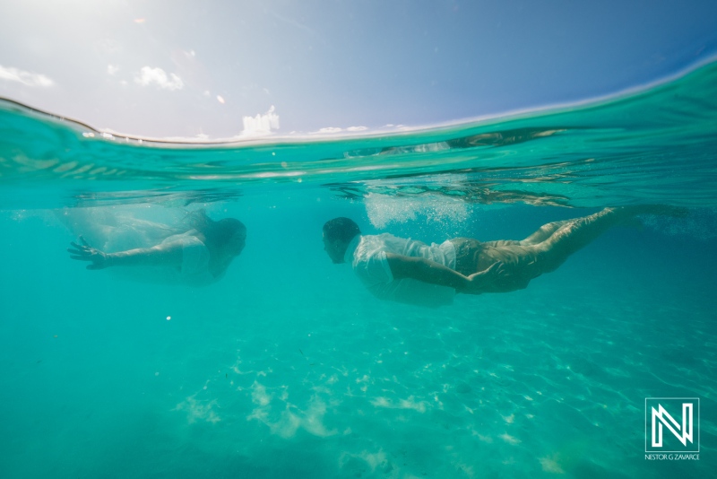 Trash the dress photoshoot at Cas Abao Beach in Curacao during bright midday sun with stunning turquoise water