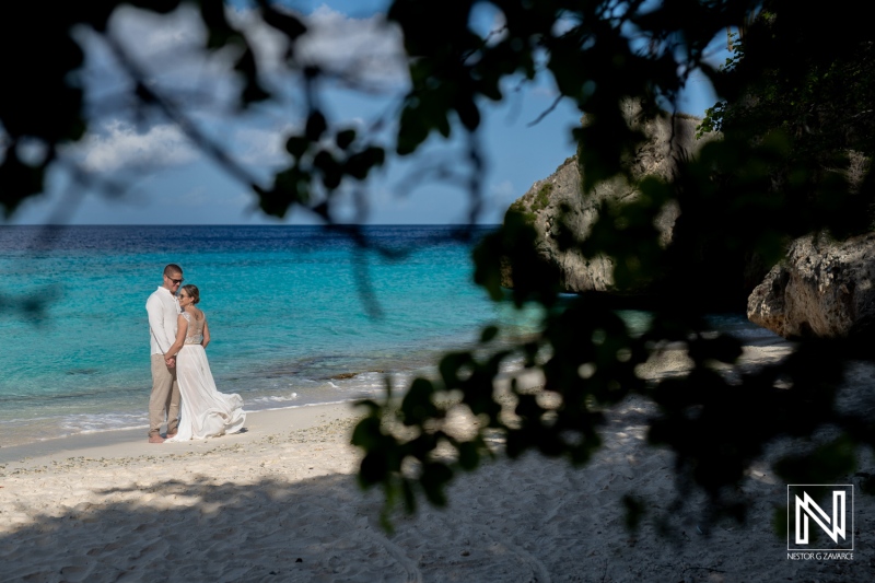 A Couple Exchanges Vows During a Romantic Beach Wedding Ceremony Along the Serene Coastline on a Sunny Day