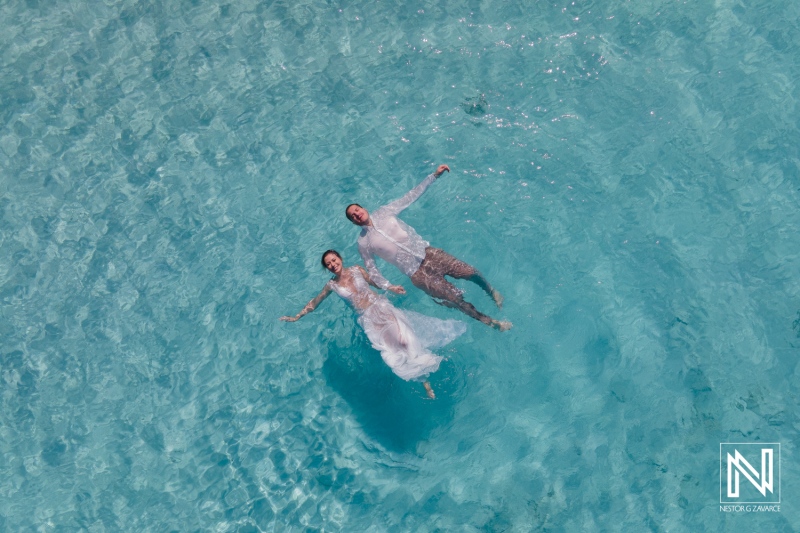 A Couple Floats Peacefully in Clear Turquoise Waters, Enjoying a Moment of Tranquility and Connection in a Serene Tropical Setting on a Sunny Day