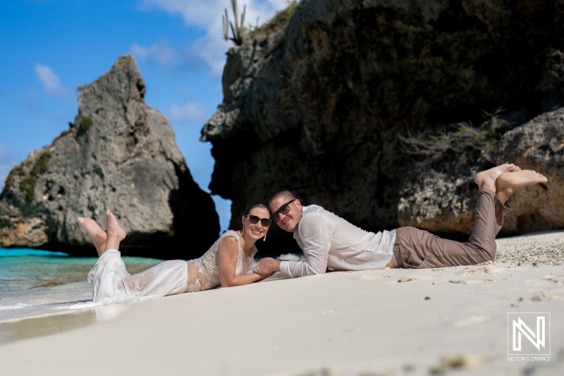 Couple Enjoys a Romantic Moment on a Serene Beach at Sunset, Capturing the Beauty of Nature and Love While Lying on the Soft Sand Near the Coast