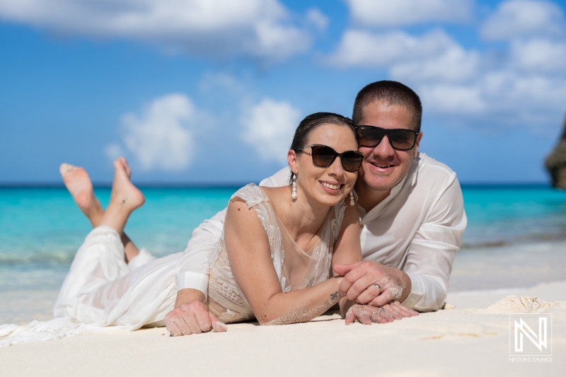 A Couple Enjoying a Romantic Day at the Beach, Lounging on the Sand With Sunny Skies and Turquoise Waters in the Background