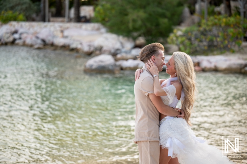 Couple enjoys a trash the dress session at Baoase Luxury Resort in Curacao by the water during a sunny day