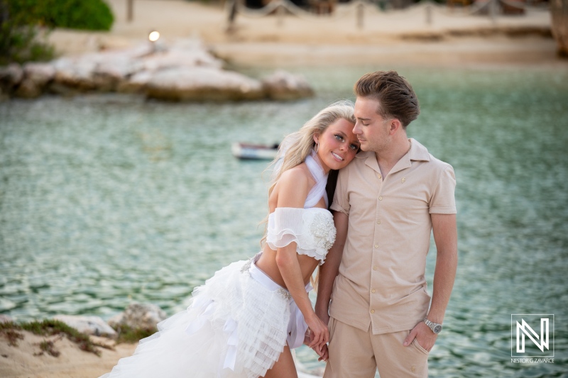 Couple enjoys a trash the dress session at Baoase Luxury Resort in Curacao during sunset by the water