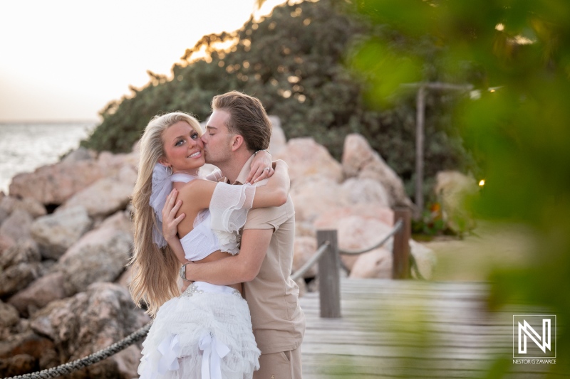 Couple enjoys Trash the Dress session at Baoase Luxury Resort in Curacao during sunset while embracing and smiling