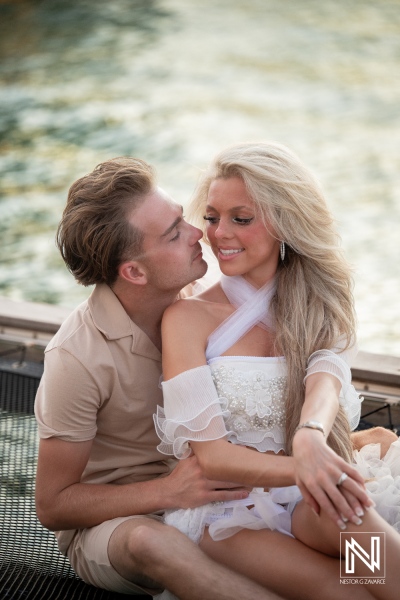 Couple enjoys trash the dress session at Baoase Luxury Resort in Curacao by the water during sunset