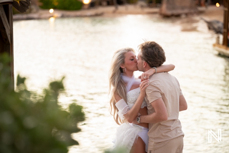 Couple enjoys trash the dress session at Baoase Luxury Resort in Curacao near water during sunset