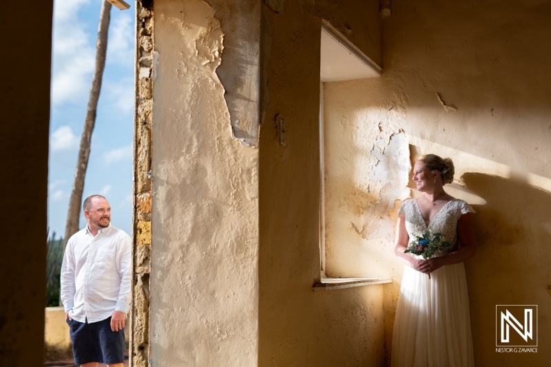 Couple enjoys a romantic moment at Cas Abao Beach, Curacao during a Trash the Dress session, capturing the beauty of their love and the stunning surroundings