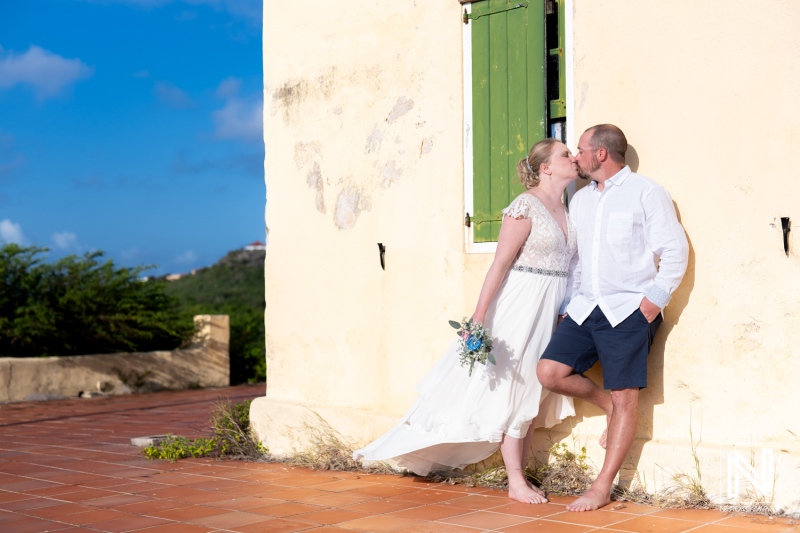 Couple enjoys a romantic moment during Trash the Dress session at Cas Abao Beach in Curacao on a sunny day