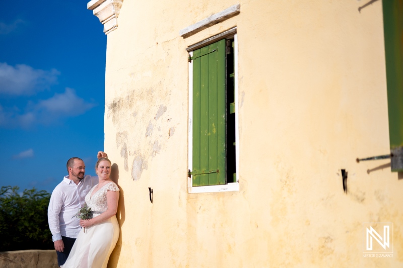 Elegant wedding couple captures romantic moments during Trash the Dress session at Cas Abao Beach in Curacao under sunny skies