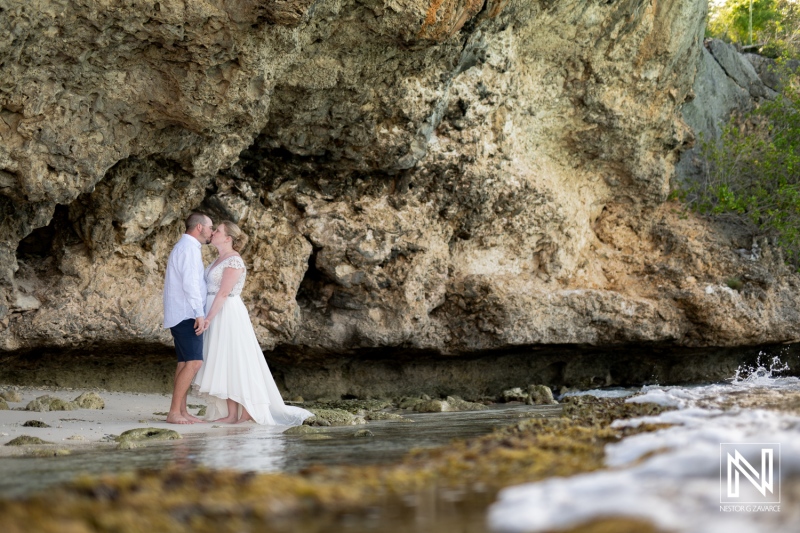 Couple shares a romantic moment during a Trash the Dress session at Cas Abao Beach in Curacao at sunset