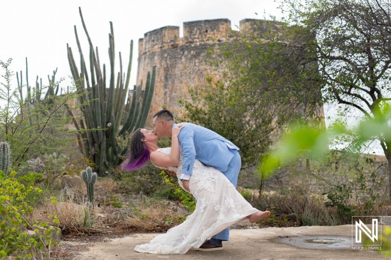 Couple enjoys a romantic trash the dress session in Curacao with historic backdrop and vibrant nature