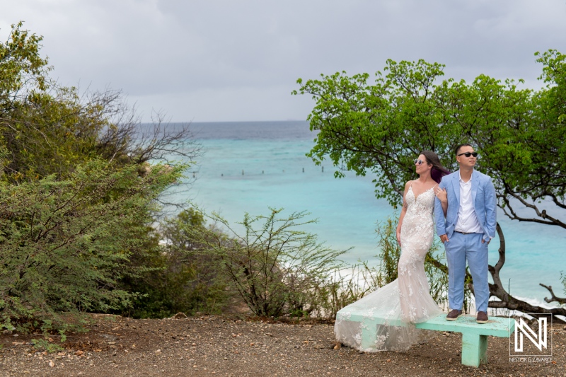 Couple enjoys trash the dress session by the ocean in Curacao with stunning views and a casual vibe