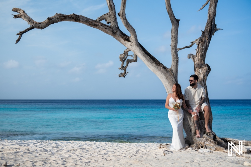 Couple enjoys romantic Trash the Dress session at scenic Cas Abao Beach in Curacao during a sunny day