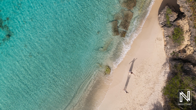 Couple enjoying a Trash the Dress session on Cas Abao Beach in Curacao with turquoise waters and sandy shores