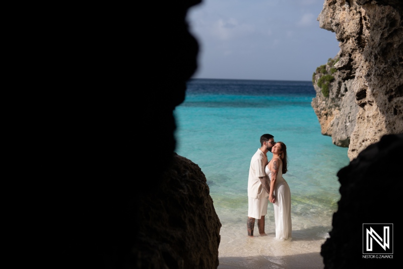 Couple shares an intimate moment during a Trash the Dress session at Cas Abao Beach in Curacao with stunning turquoise waters